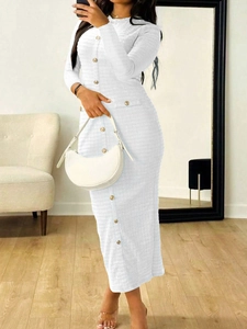 Detailed texture of white knit long-sleeve dress with elegant button accents on the front