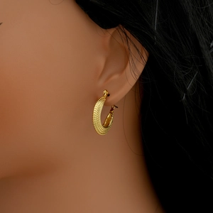 Detailed close-up of gold twist texture on 18k plated stainless steel hoop earrings