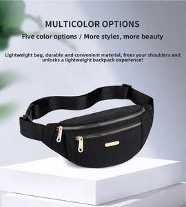 Detail of black nylon waist bag with three golden metal zippers and adjustable strap