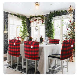 Detail of red and black buffalo plaid chair cover with a white pompom for Christmas decor