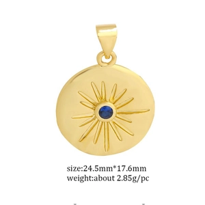 Detail of gold sun pendant with blue zircon center including size 24.5mm x 17.6mm