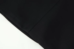 Close-up of the black fabric texture and neat stitching of this fashion waist dress