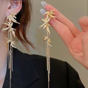 Elegant gold bamboo leaf tassel earrings with silver needles for a stylish modern look
