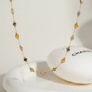 Detail of gold-plated chain with colorful natural stone beads and gold round beads