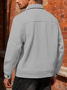 Detail view of the gray corduroy jacket back seam and textured fabric from a side angle