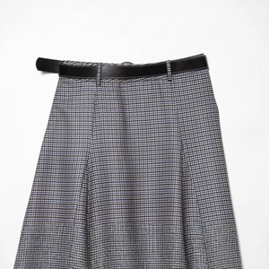 Fashionable high waist plaid midi skirt with black leather belt on white background