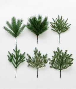 Detailed view of six different artificial pine needle branch styles for DIY Christmas decor