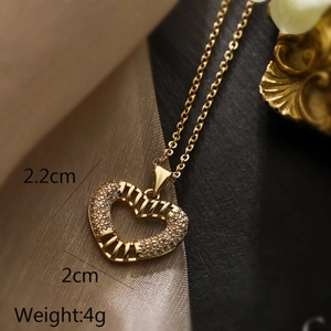 Macro shot of gold heart pendant necklace showing dimensions 2.2cm height and 2cm width