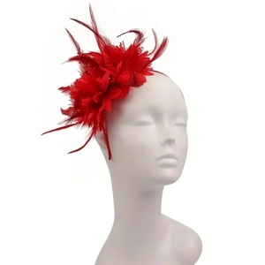 Detail of red feather flower headpiece on a mannequin for bridal or party wear