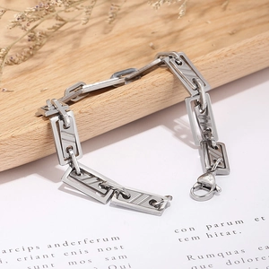 Close-up of geometric stainless steel bracelet with rectangular hollow links and lobster clasp