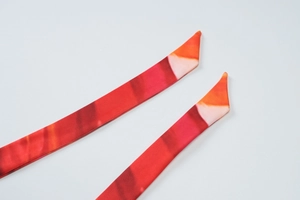 Detailed macro view of the silky gradient floral fabric with bias-cut ends and fine texture