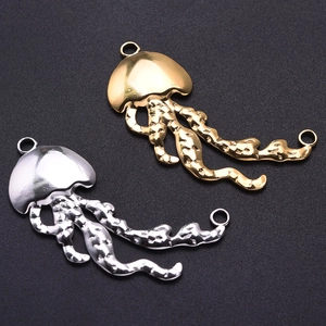 Detailed view of jellyfish pendants in gold and silver finishes with hammered textures