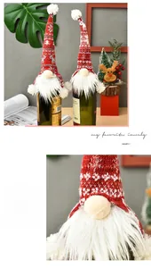 Detail of knitted Christmas gnome wine bottle cover with snowflake patterns and pompom
