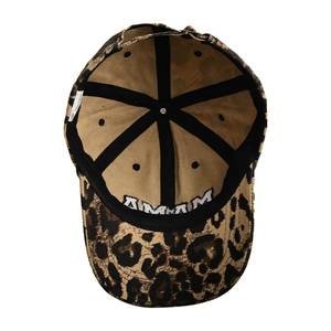 Detailed interior of leopard print baseball cap featuring inner sweatband and metal buckle