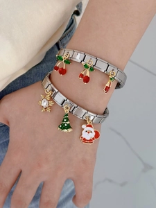 Detail of Italian style stainless steel charm bracelet with festive enamel pendants