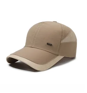 Close-up of khaki mesh baseball cap showing breathable panels and metal fashion badge