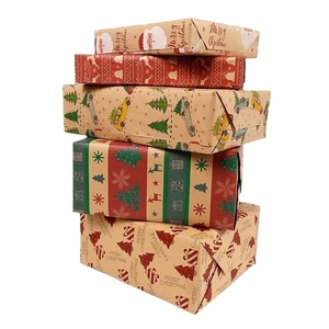 Brown kraft Christmas wrapping paper rolls with festive deer and tree patterns