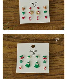 Detail of Christmas stud earring set featuring resin reindeer, snowflakes and trees