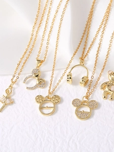 Detailed view of gold plated necklaces with ballet, Mickey, and bear charm pendants