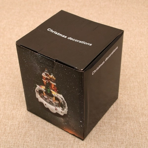 Festive Christmas gift box featuring gingerbread man train and snowy town illustrations