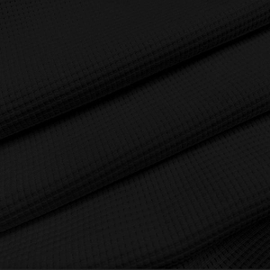 Detailed close-up of premium black waffle texture fabric on long-sleeve Polo shirt