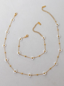 Detail view of handmade beaded daisy necklace and bracelet set in stainless steel