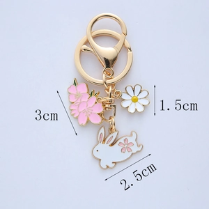 Detail view of rabbit and floral keychain pendants with precise size measurements