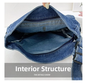 Detailed interior view of the dark blue denim crossbody bag with secure zipper closure