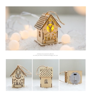 Detail of wooden Christmas house ornament with LED light, laser deer motif and XMAS text