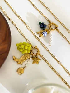 Detailed shot of 18K gold plated titanium necklaces with colorful charms and pearls