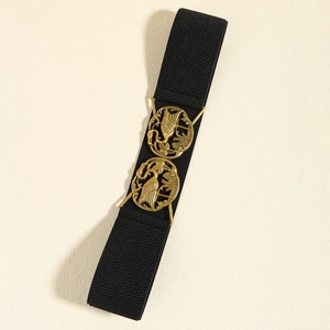 Detail of black elastic waist belt featuring dual golden crane metal buckles with intricate patterns