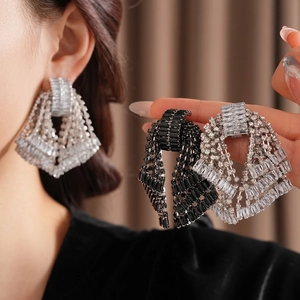 Luxury oversized bow tassel earrings with silver finish and sparkling crystal fringe