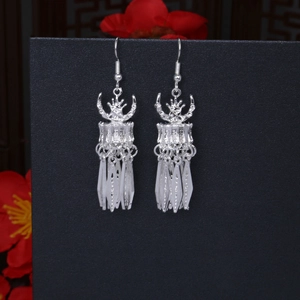 Detailed view of silver bohemian tassel earrings featuring ethnic floral metal design