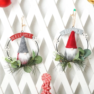 Pair of festive Christmas gnome wreaths with Welcome signs and realistic greenery