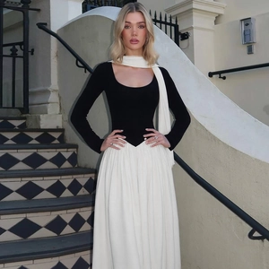 Detail of contrast stitching between the black knit bodice and white pleated chiffon skirt