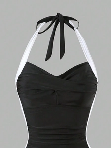 Close-up of halter neck lace-up and twist-front knot detail on slimming swimsuit