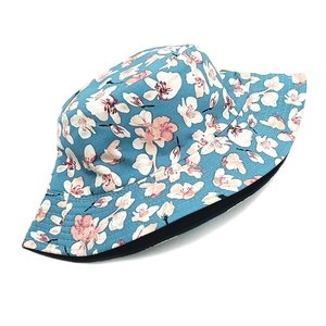 Detailed view of the sky blue bucket hat featuring cherry blossom patterns and stitching