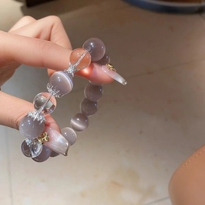 Macro shot of grey cat eye stone bracelet with silver star accents and crystal beads