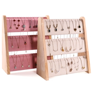 Three-tier wooden necklace display stand with pink and beige velvet rolls for jewelry