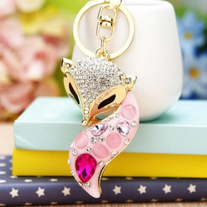 Macro shot of gold fox keychain featuring pink rhinestones and a polished metal ring