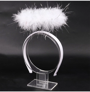 Detailed view of a white feathered angel halo headband with silver glittery tinsel details