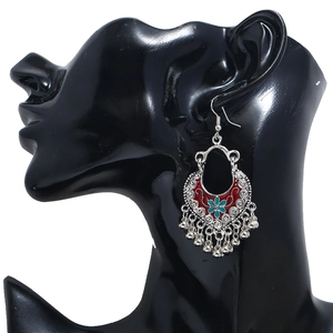 Vintage Indian style bell tassel earrings with red crescent and blue flower on model