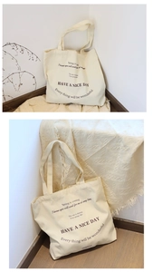 Beige canvas tote bag with black typography shown in a minimalist home setting decor