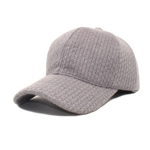 Detailed close-up of grey baseball cap featuring premium knitted wool texture and minimal design
