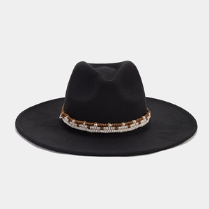 Detailed texture of black felt fedora hat featuring a woven ethnic style band trim