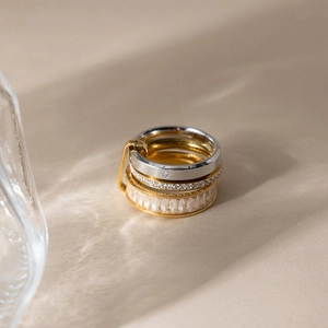 Three-piece stacked ring set in 18K gold and silver colors with white zircon accents