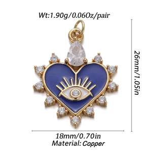 Detail of gold heart pendant with blue evil eye enamel and cubic zirconia insets