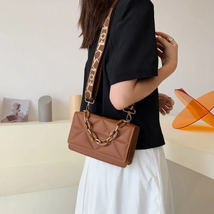 Brown quilted chain crossbody bag with wide jacquard strap for a modern fashion look