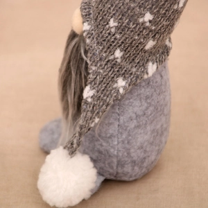 Detailed view of Nordic Christmas gnome with grey knit hat and white fuzzy beard decoration