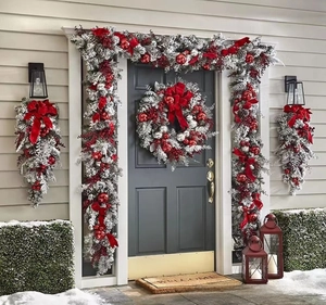 Detailed set of flocked Christmas wreaths and garlands with red berries and bows for door decor